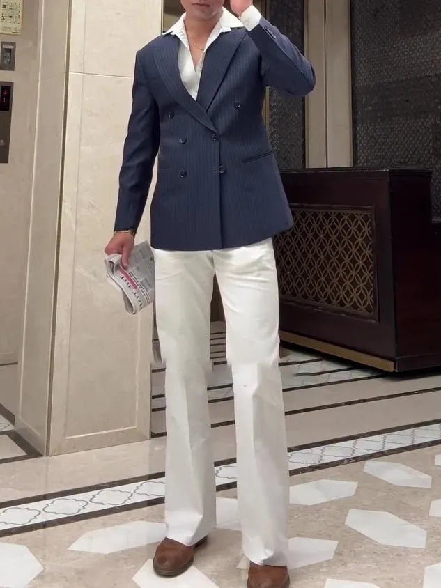 Men's striped double-breasted polyester blazer on a hanger, showing regular fit and length.