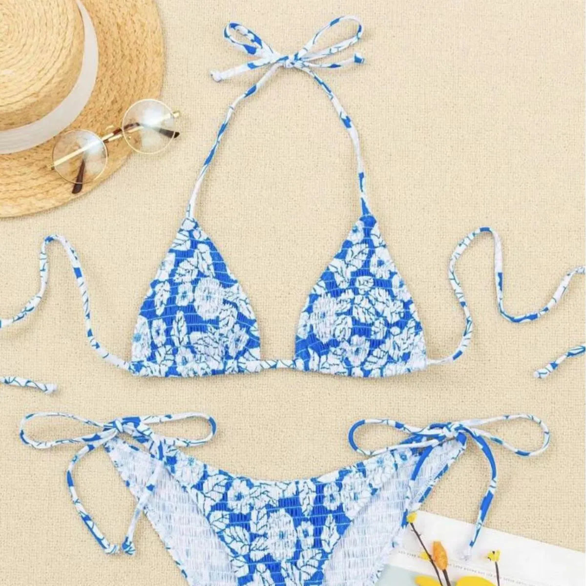 Women's floral print halter bikini swimsuit in light blue colour on a mannequin.