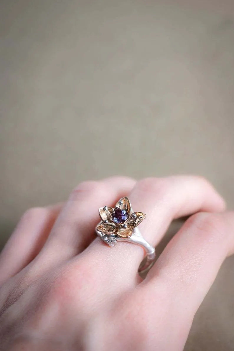 Silver two-tone floral geometric women's alloy ring shown on a finger, demonstrating its design and fit.