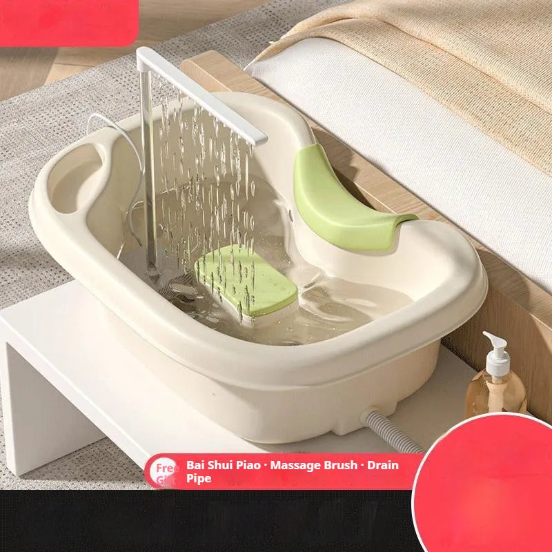 Portable plastic shampoo basin with head pad, circulating pump and massage brush for bed use.