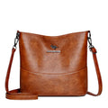 Women's soft leather bucket shoulder bag in a solid colour with visible sewing lines.