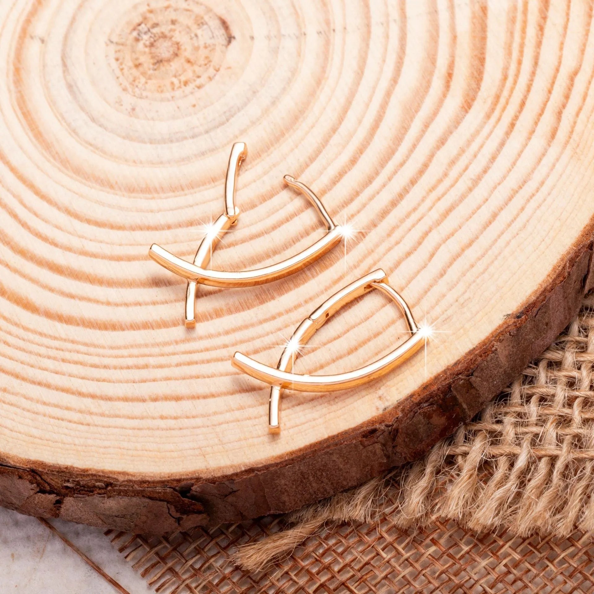 Rose gold cross shaped earrings made from copper with geometric design