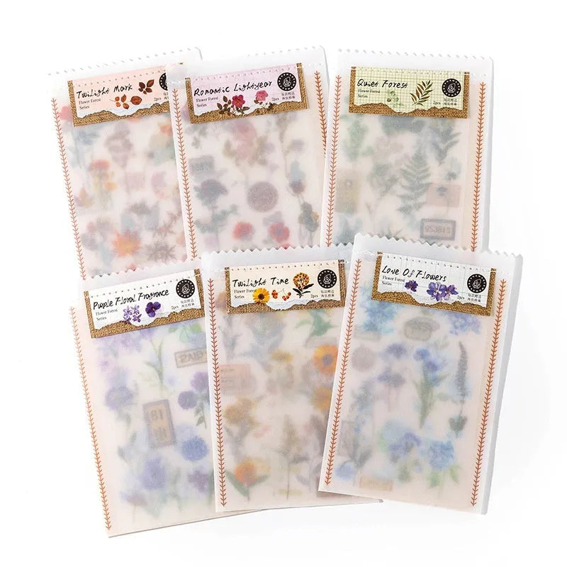 Huazhisen art sticker material pack showing printed transfer paper and cotton linen sheets in forest and romantic designs.