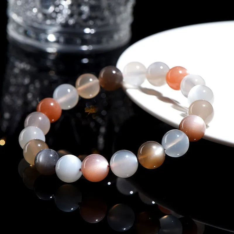 Natural colourful moonstone unisex bracelet with 8mm beads on a wrist.