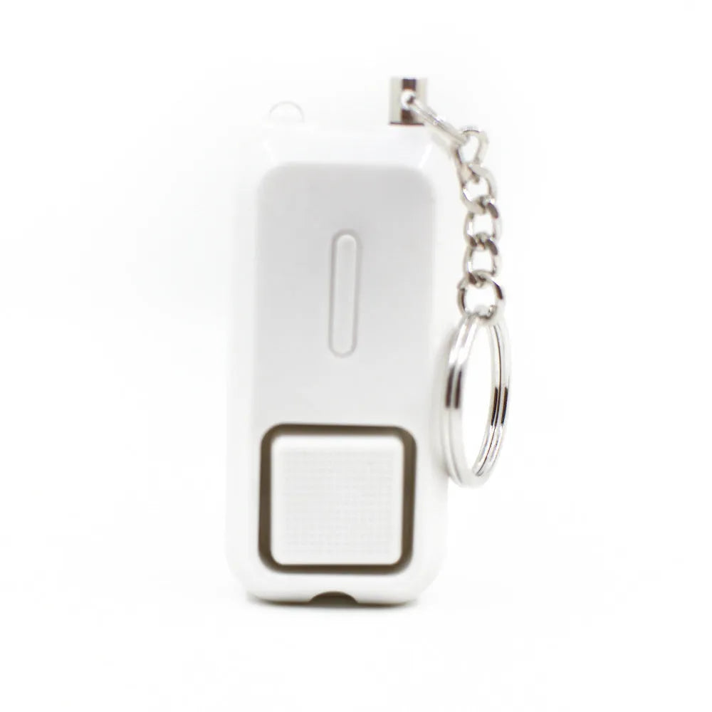 Small pink personal safety alarm on a keyring with a white box.
