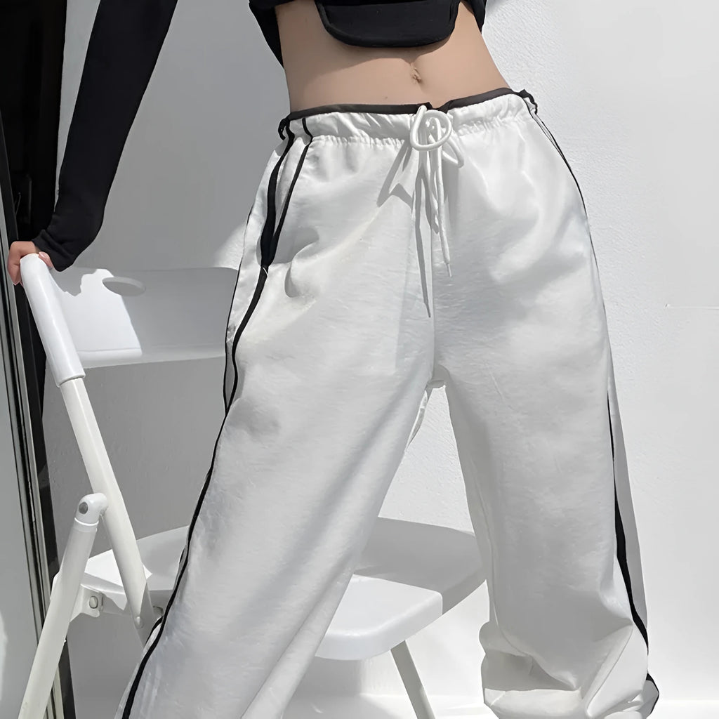 Women's navy blue loose straight leg trousers with white ribbon contrast pattern detail