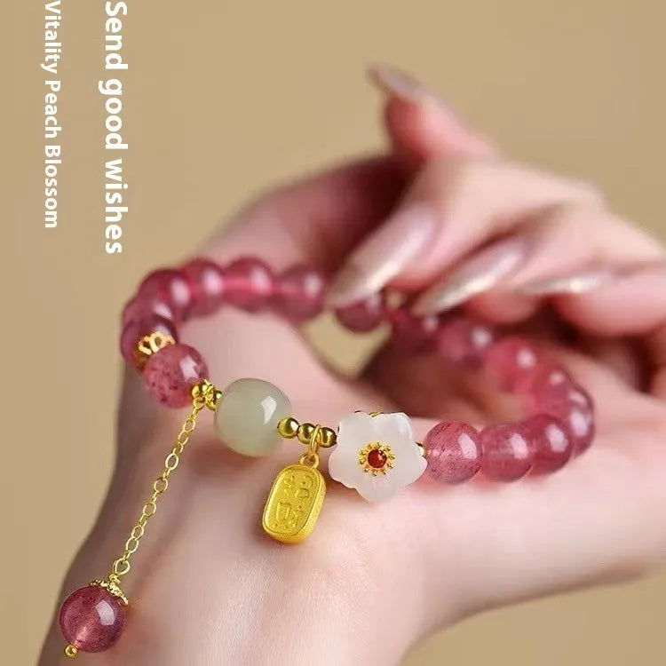 Handmade strawberry quartz crystal bracelet for women showing natural bead details on wrist