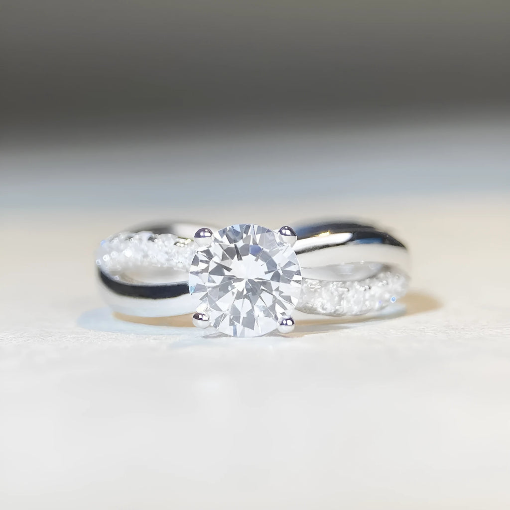Silver ring with 1 karat moissanite stone in four-claw setting and twisted geometric arms