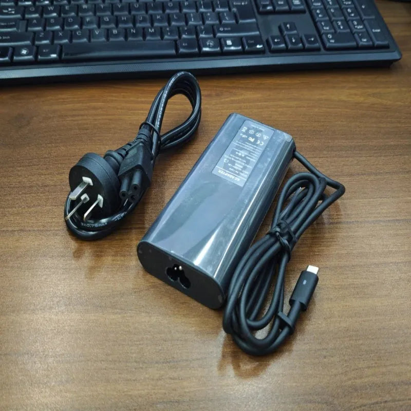 Black oval 65W laptop Type-C charger with six interchangeable international power cords