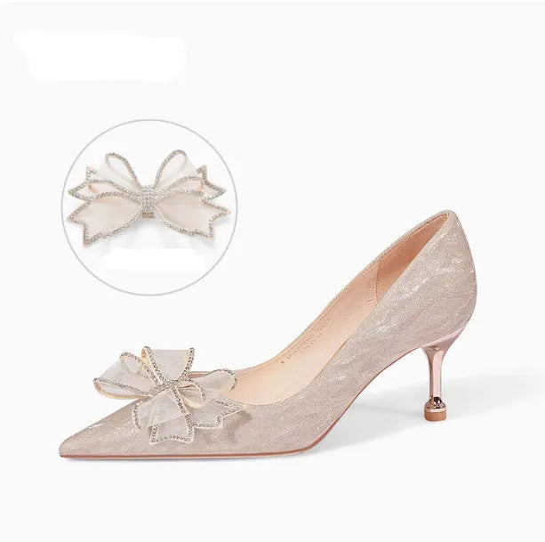 Women's champagne gold sequinned stiletto heel pumps on a white background.