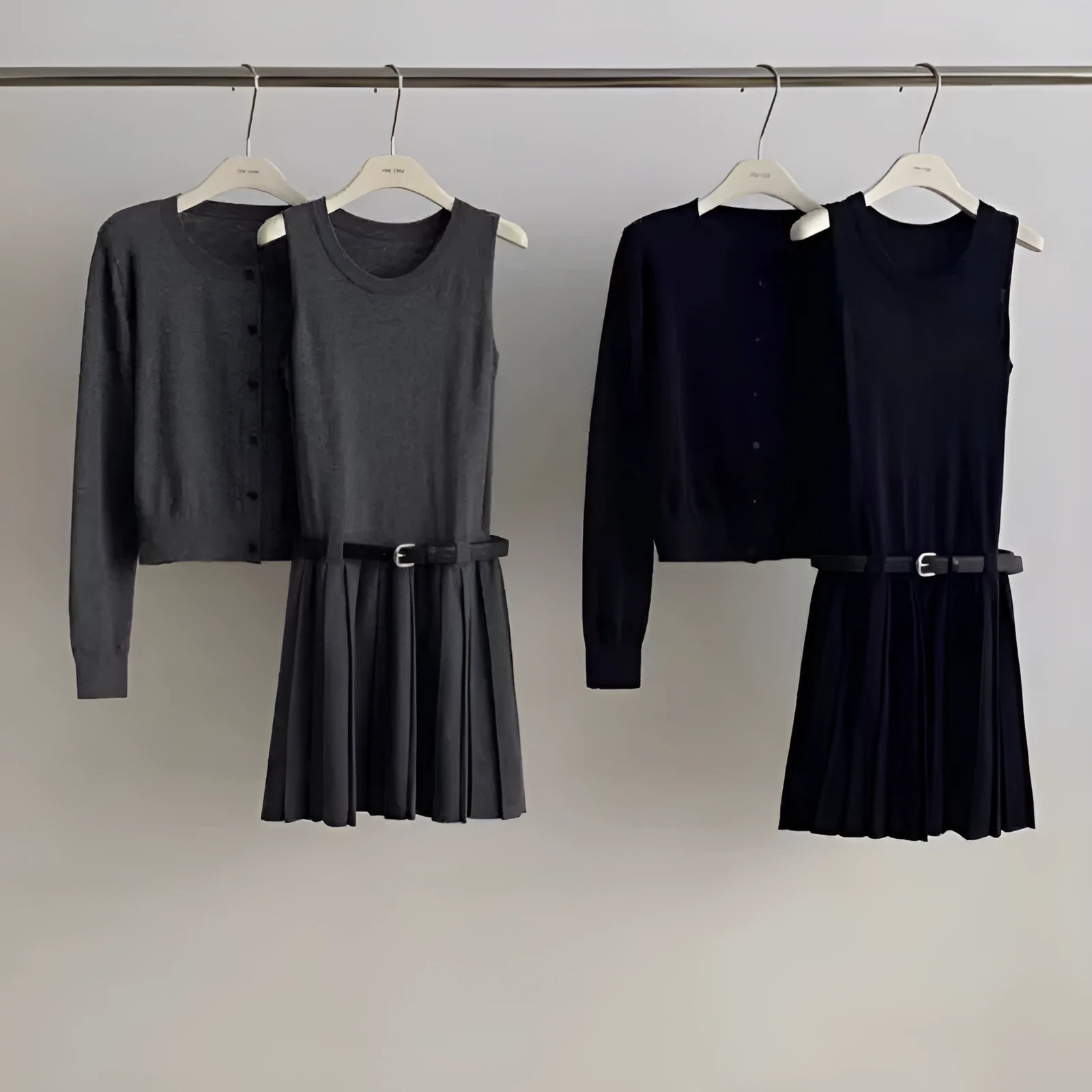 Women's art retro knitted two-piece set featuring a pleated vest skirt with 3D pattern and a long-sleeved cardigan.