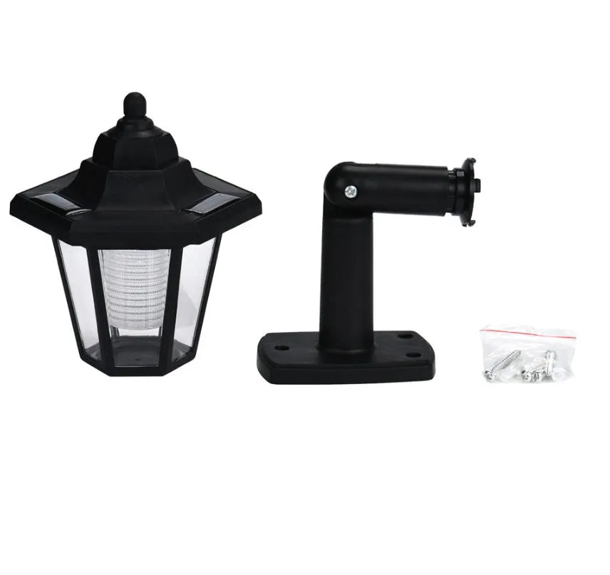 Black hexagonal solar-powered outdoor wall lamp with integrated solar panel