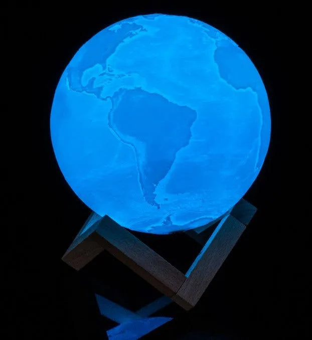 3D printed white moon lamp with detailed craters on a wooden stand, showing touch ring at base.