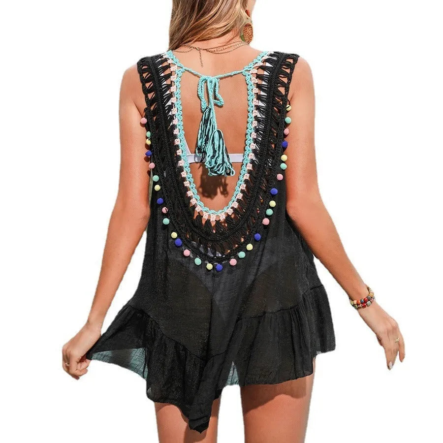 Black hand-crocheted acrylic women's beach cover-up vest with cut-out ruffles and a lining.
