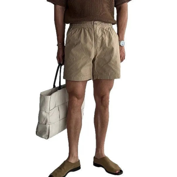 Men's loose-fit cotton sports shorts in black, shown on a white background.