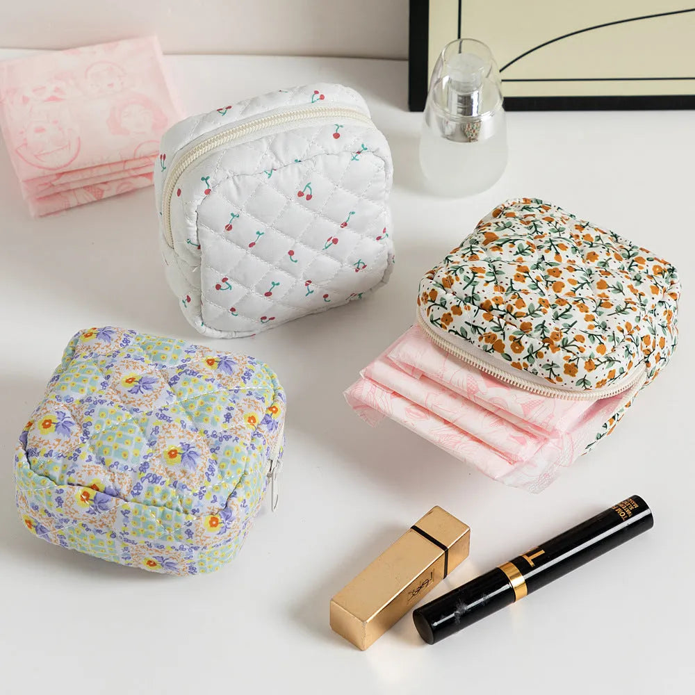 Polyester key storage wallet with floral or cherry print and sewing thread detail.
