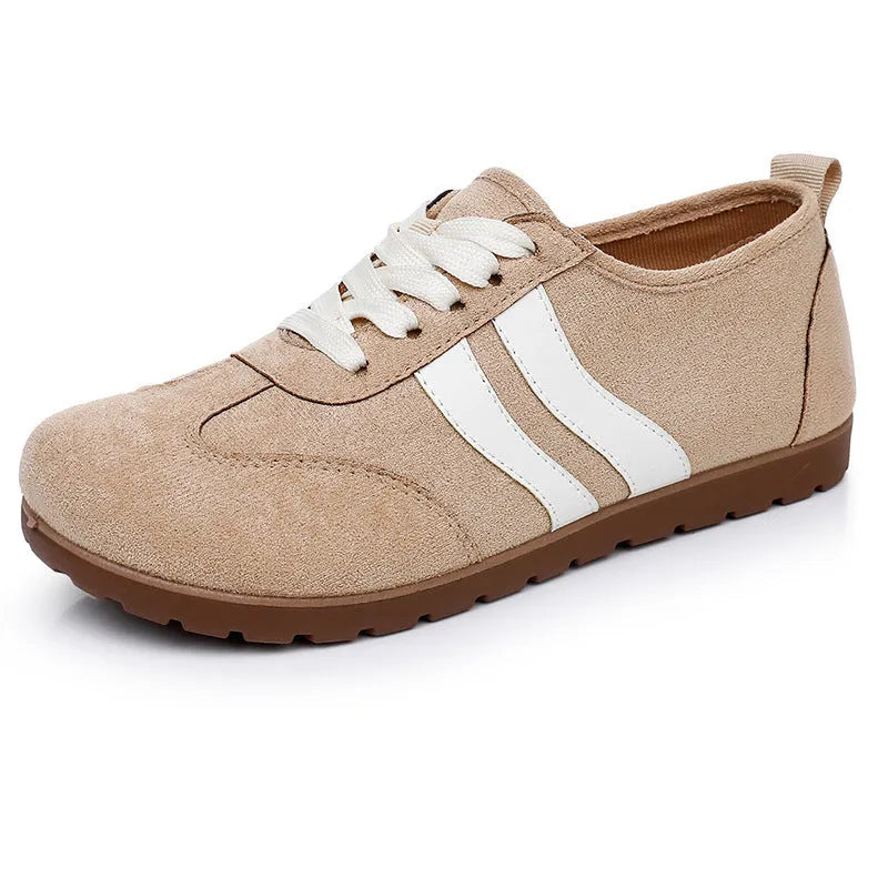 Women's vintage-style canvas sneakers with a round toe and soft rubber flat sole.
