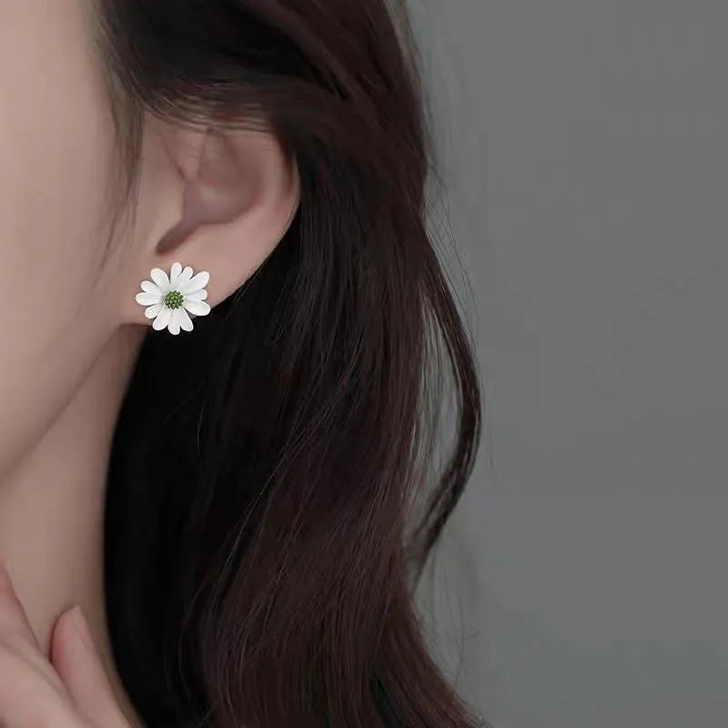 Close-up of colourful alloy flower stud earrings in cartoon style on a white background.