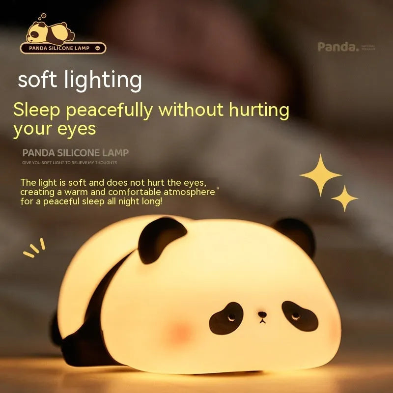 Cute cartoon panda-shaped silicone night light for children on a bedside table.