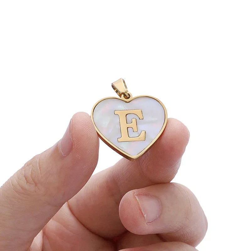 Gold plated initial necklace with white shell heart pendant and adjustable chain