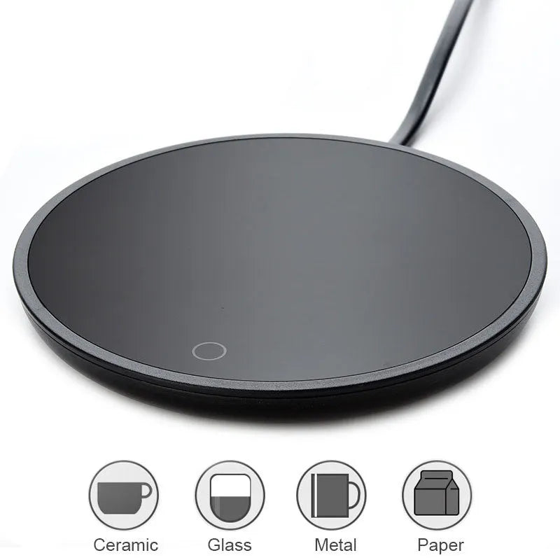 Black circular coffee cup warmer with low and high temperature switch on a desk