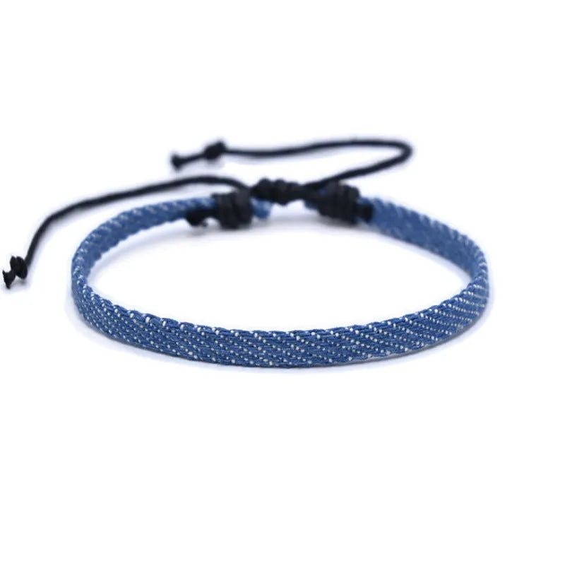 Denim fabric bracelet carrying strap with mixed materials and unisex design