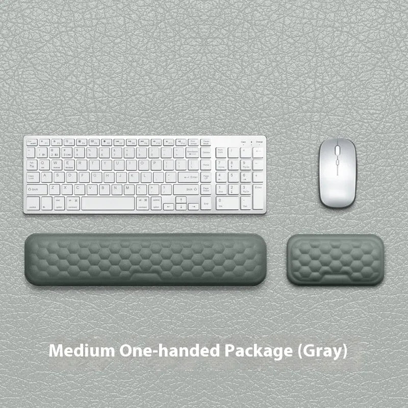 Memory foam mouse wrist pad with silicone bottom in black cloth cover on computer desk