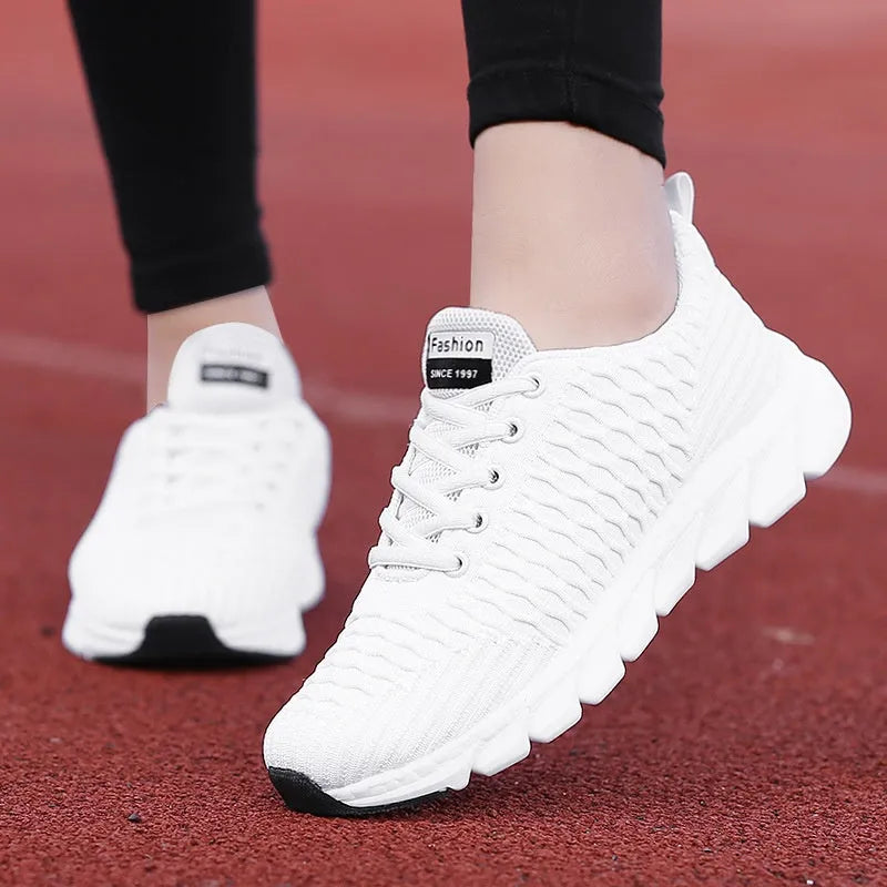 Women's running shoes in black, pink, and white with fly weaving upper and wear-resistant outsole