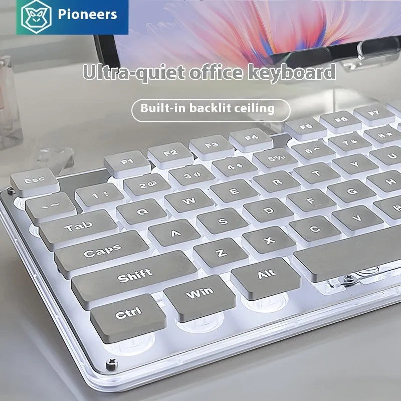 Button Mute wired keyboard and mouse set in Metal Black with blue backlighting on a desk