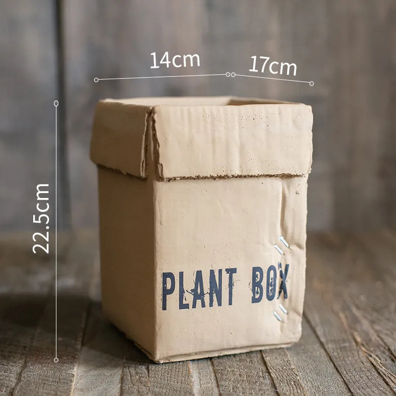Nordic-style cement brown paper box flowerpot for indoor planting on a floor.