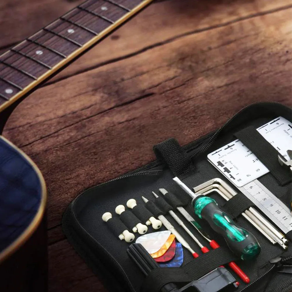 Black plastic guitar repair tool kit case open to show metal and plastic tools for guitar, bass, mandolin, banjo.