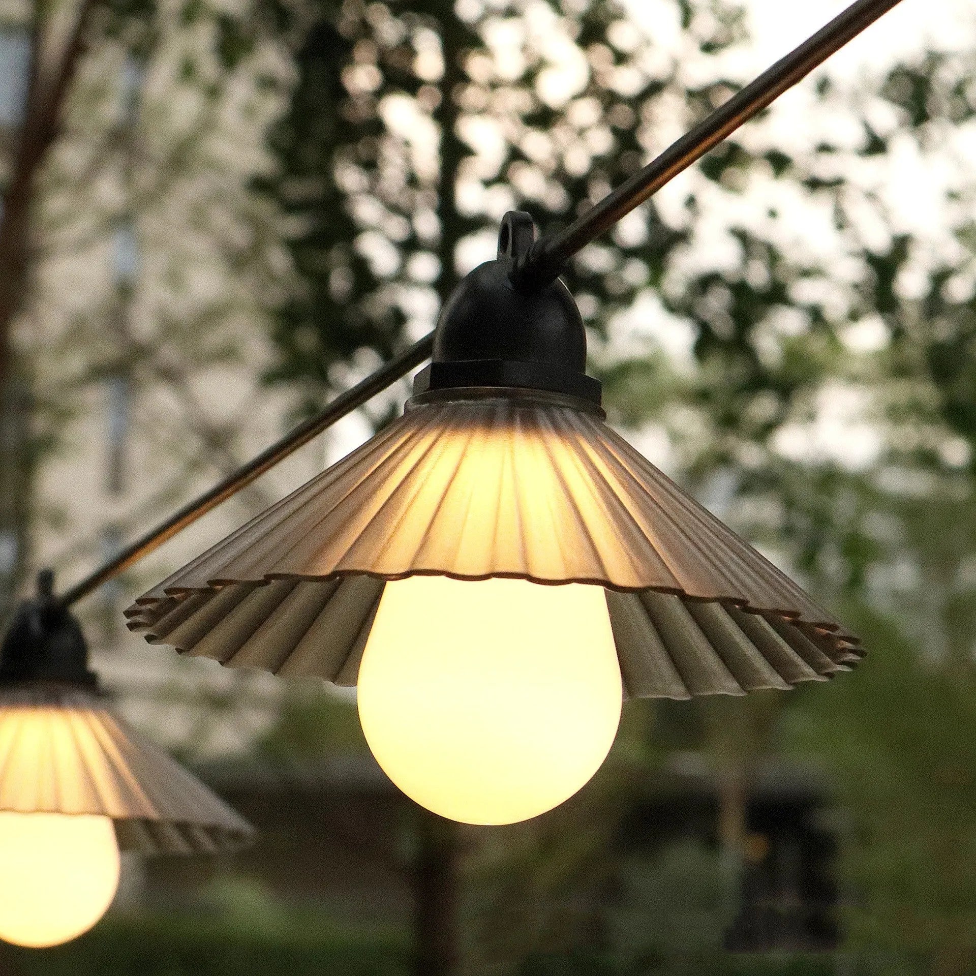 Outdoor LED string lights with flower-shaped globe bulbs in warm white or multicolour options