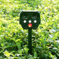 Green solar-powered ultrasonic animal repeller unit with solar panel on top