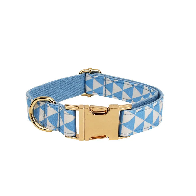 Blue cloth dog collar, leash, vest, and decorative bow four-piece pet accessory set.