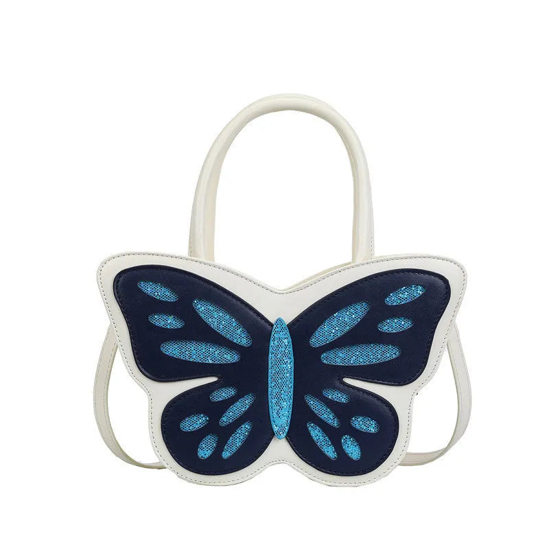 Small square white PU crossbody bag with blue contrast trim on a table.