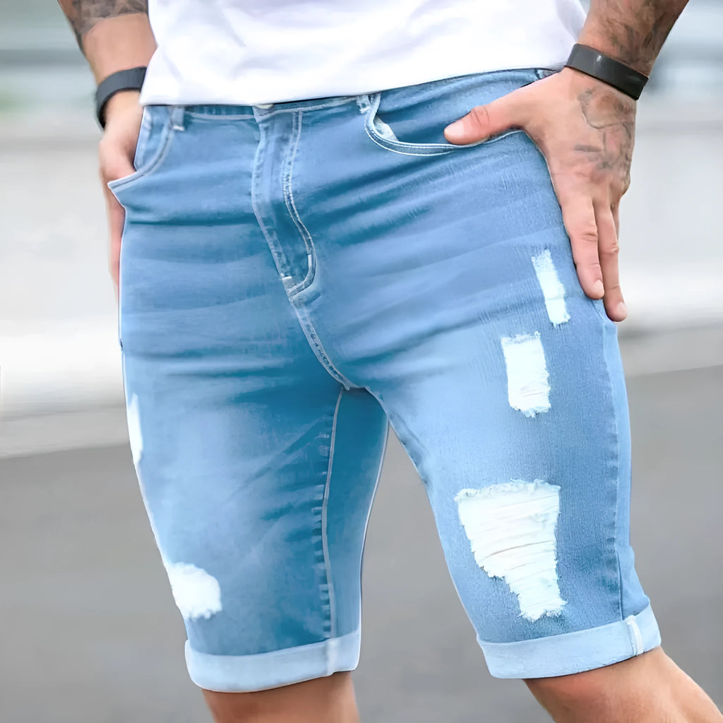 Sky blue distressed denim shorts with multi-hole design and low waist straight leg cut