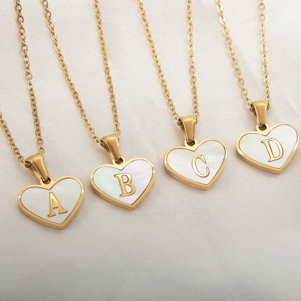 Gold plated initial necklace with white shell heart pendant and adjustable chain