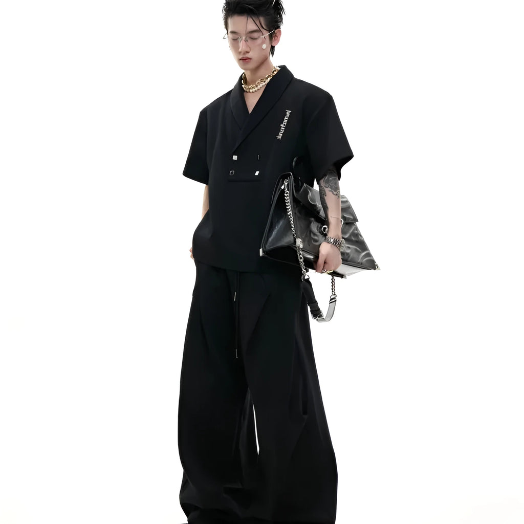 Men's dark grey cotton sports suit with V-neck short sleeve jacket and matching bottoms showing padded shoulder detail