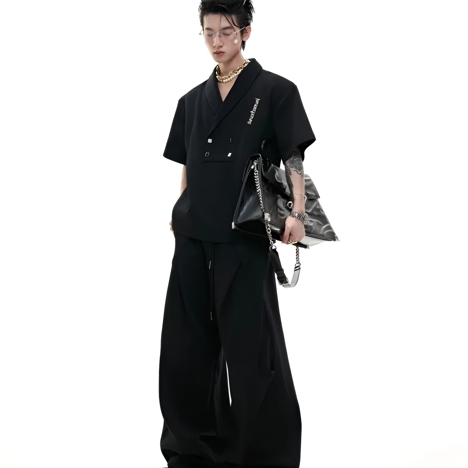 Men's dark grey cotton sports suit with V-neck short sleeve jacket and matching bottoms showing padded shoulder detail
