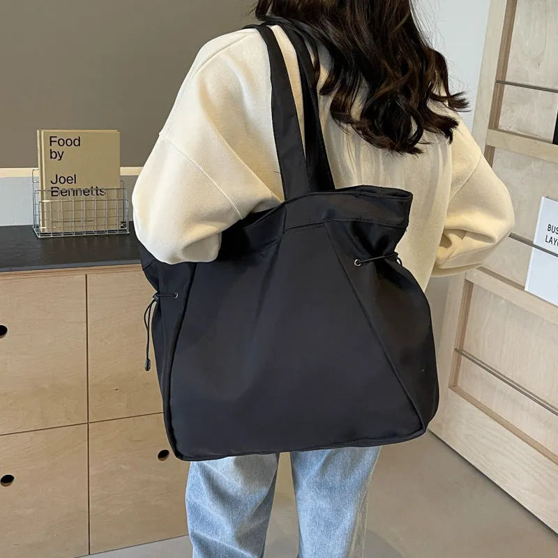 Soft Oxford cloth folding commuter shoulder tote bag shown in light grey colour.