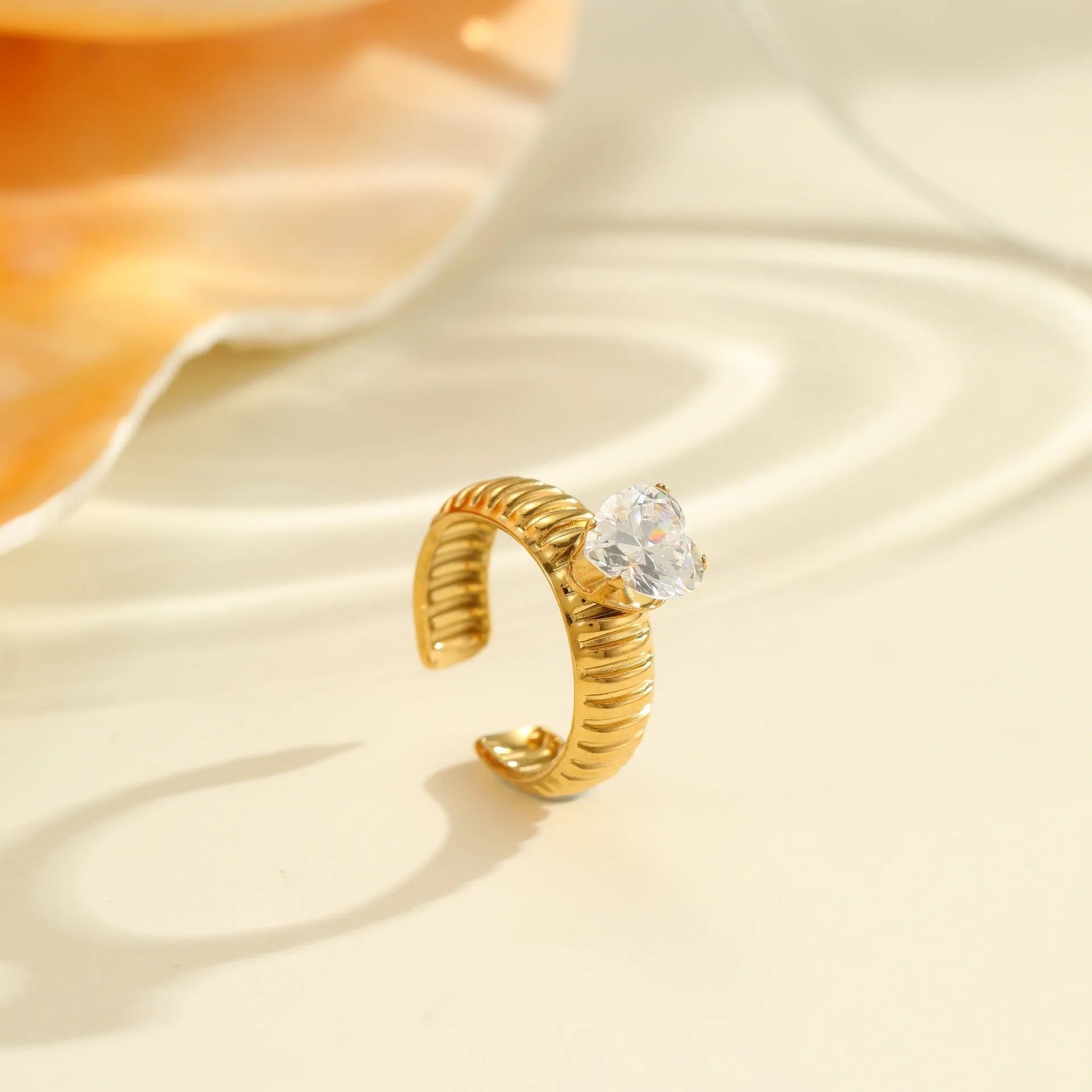Gold electroplated stainless steel ring with geometric heart shape design and zircon accents