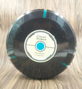 Black or white AC robot vacuum cleaner on a wooden floor showing its 23-inch square size and low profile.