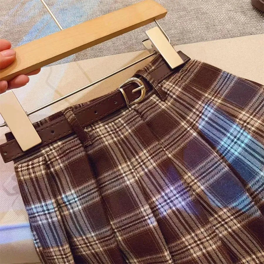 Girls' plaid pattern pleated A-line skirt in cotton blend fabric.