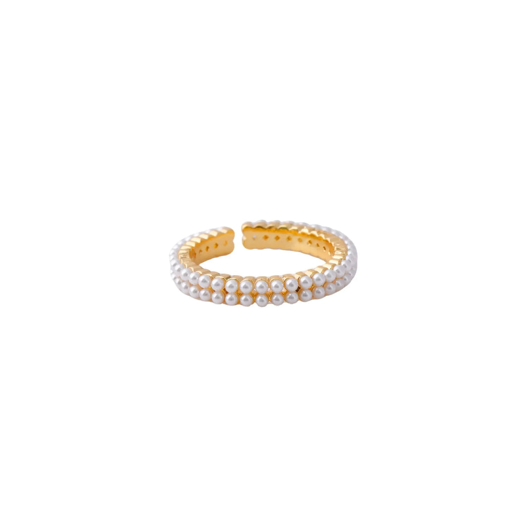 Gold geometric ring with open mouth design and pearl elements on female hand