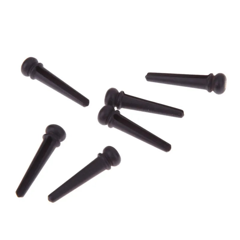 Set of six matt black ebony guitar bridge pins with 5.3mm diameter for folk acoustic guitars.