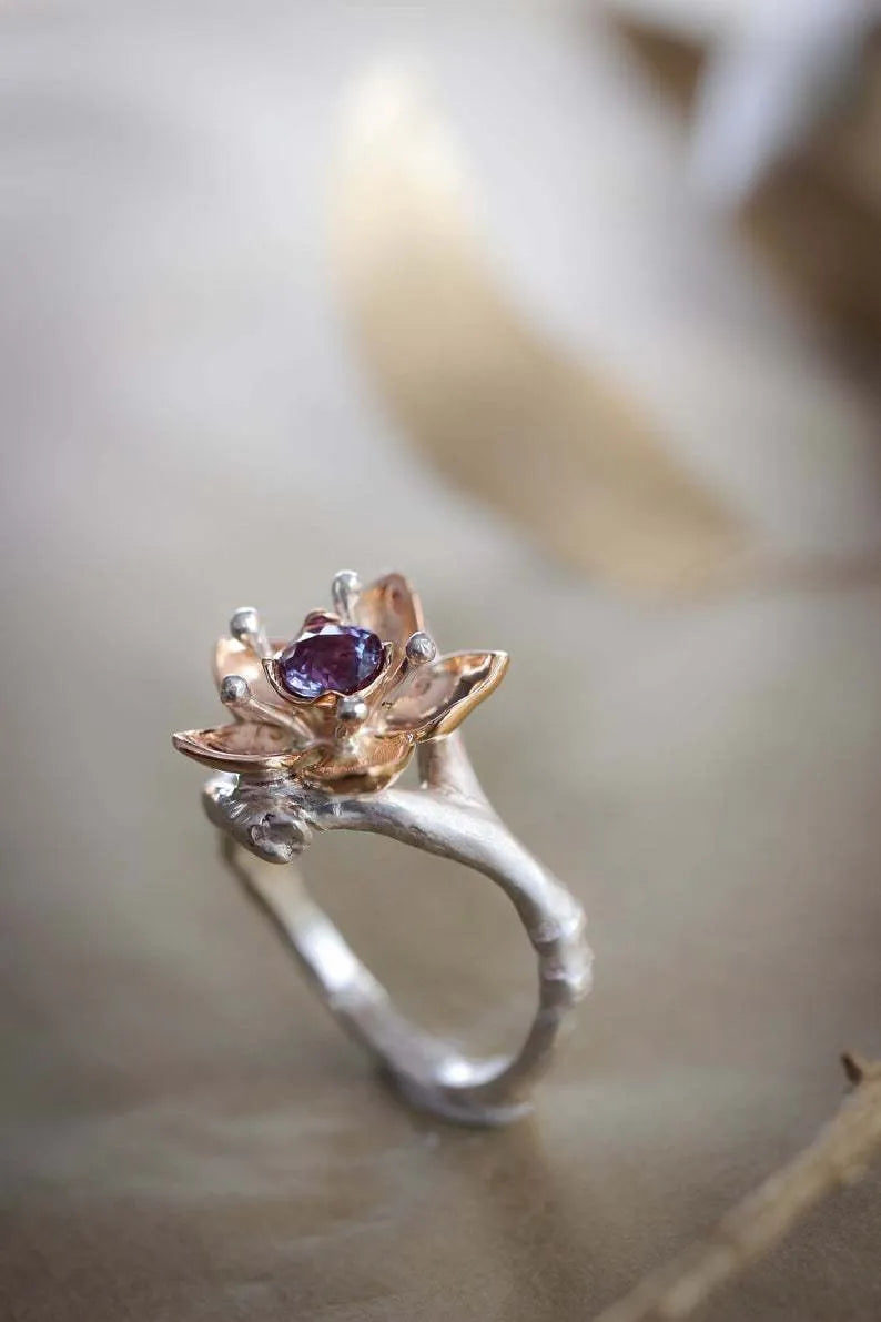 Silver two-tone floral geometric women's alloy ring shown on a finger, demonstrating its design and fit.