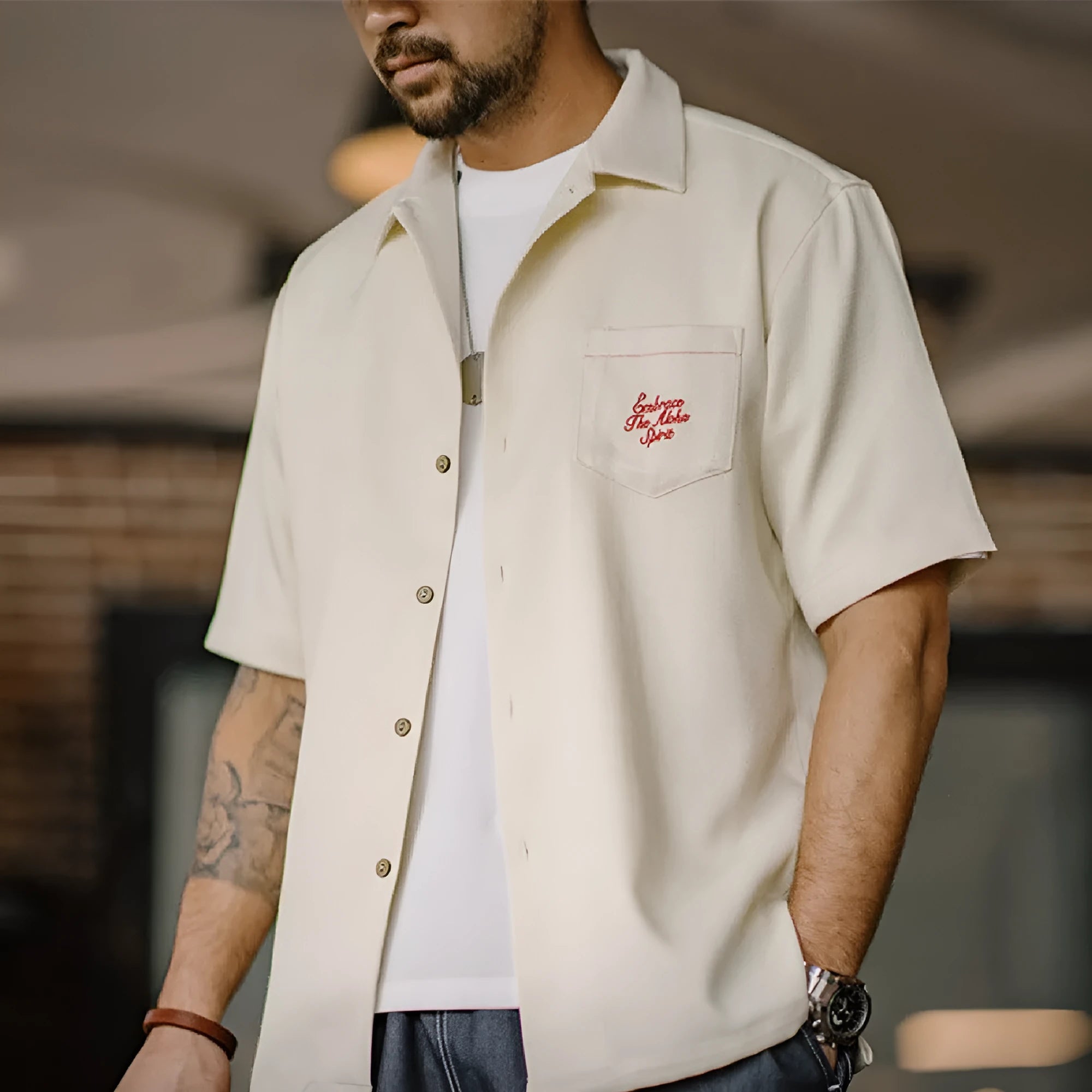 A light apricot men's shirt with a bamboo plant pattern and a relaxed Cuban collar.
