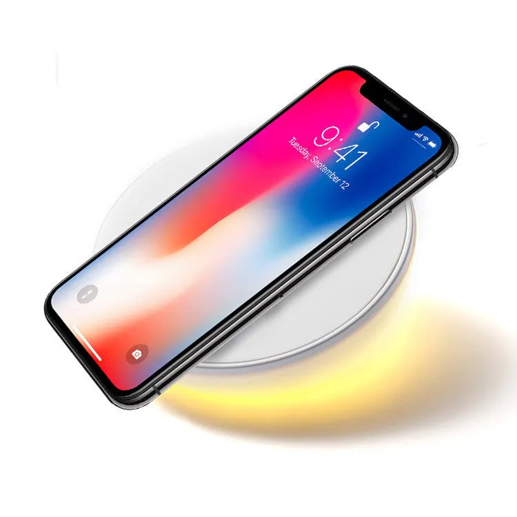White wireless charging pad with digital clock display and three control buttons