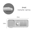Silicone faucet splash guard pad in beige colour with sloped design and visible drain channels