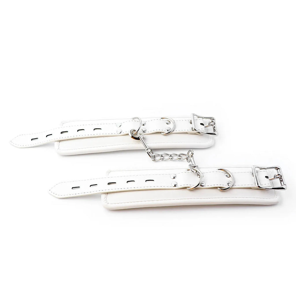 White PU sponge adult restraint set showing handcuffs, foot cuffs, and a neck cuff.
